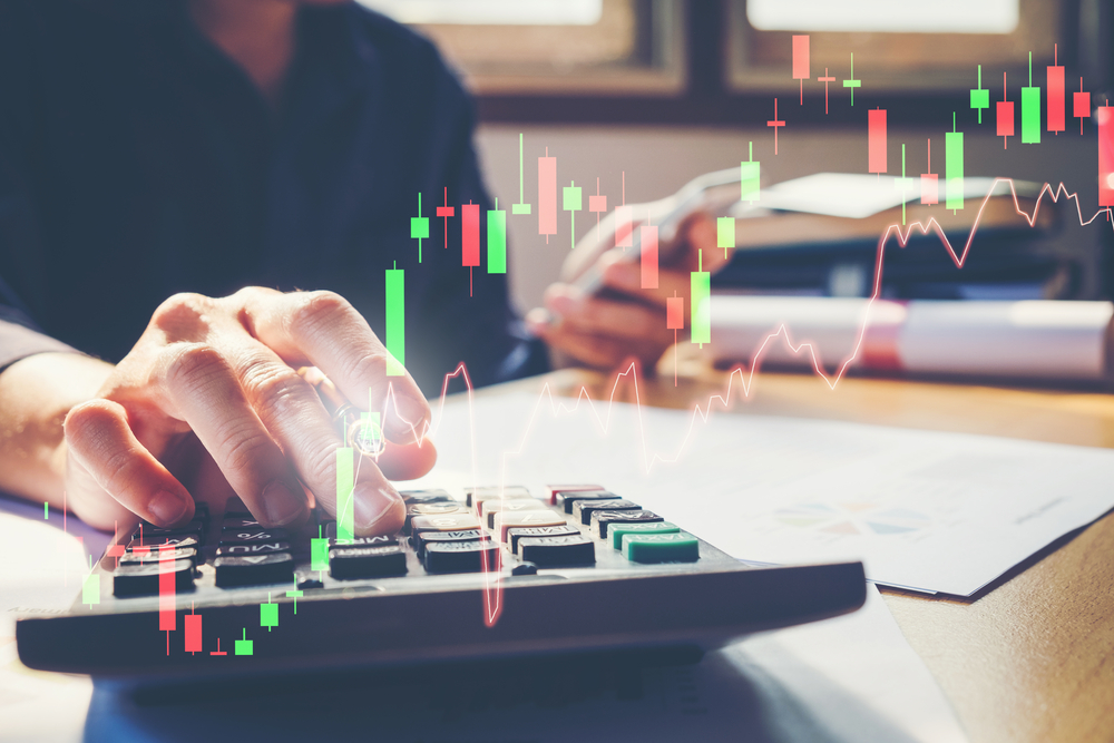 A day trader calculating profits from a trade